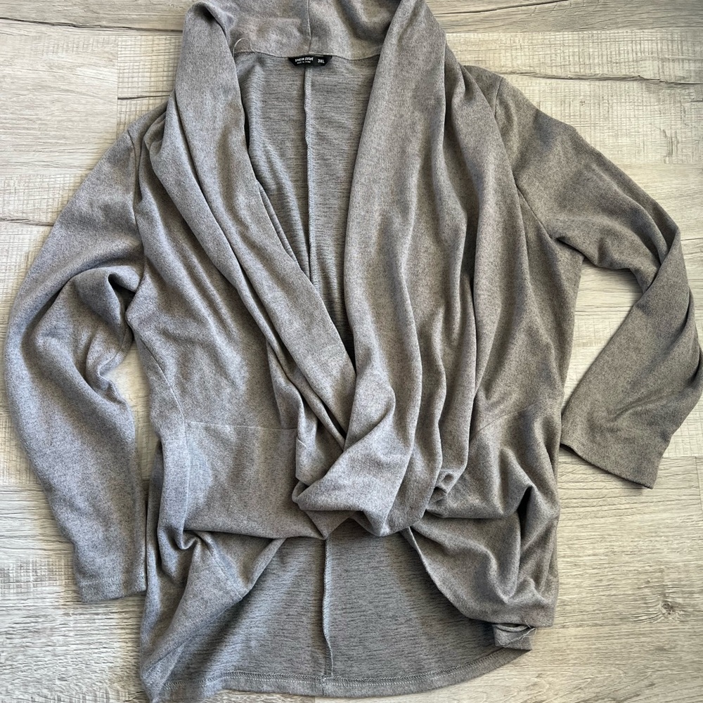 Cardigan pullover, opened chest. The waist area has a criss cross design.